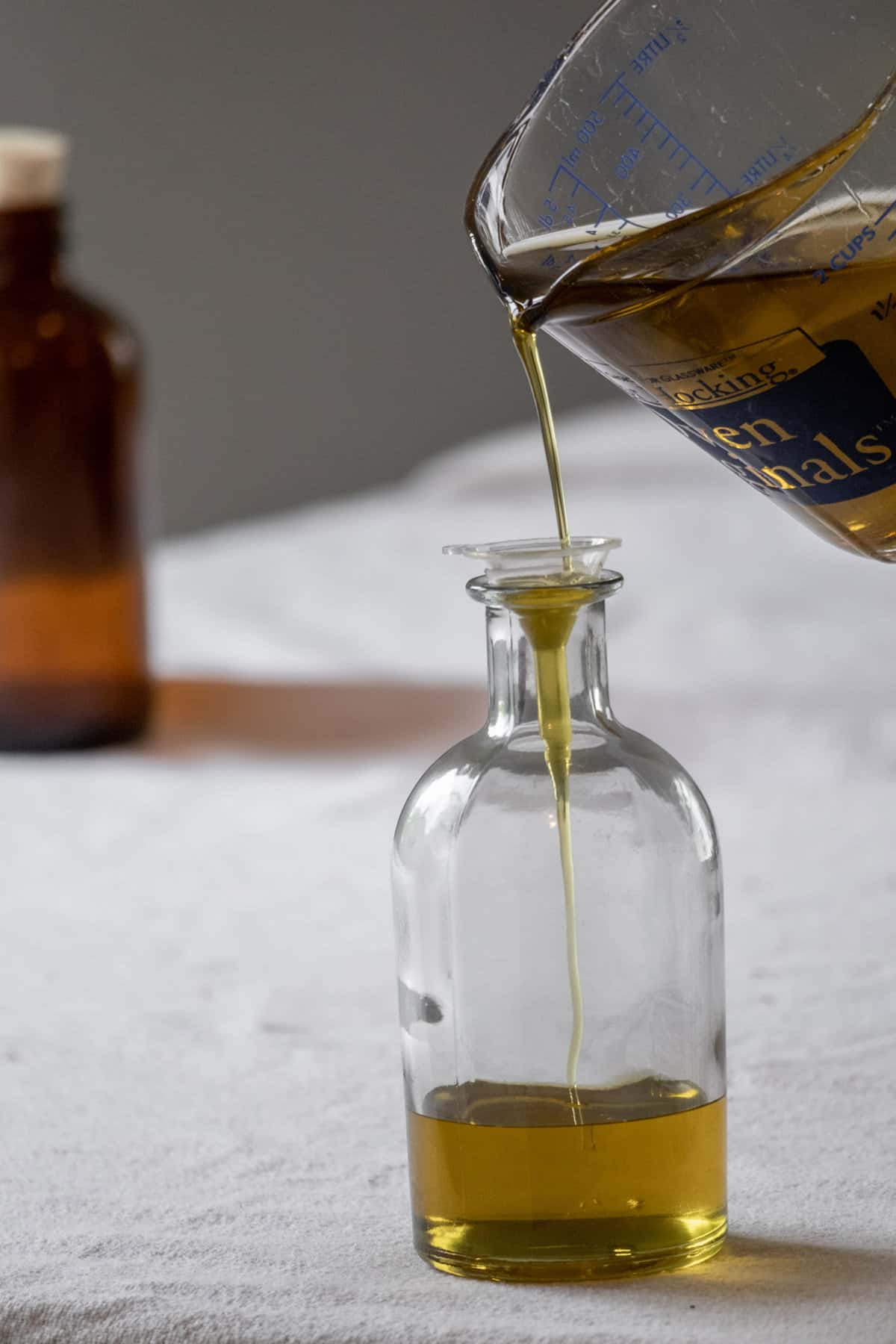 Decanting DIY comfrey oil into an apothecary bottle