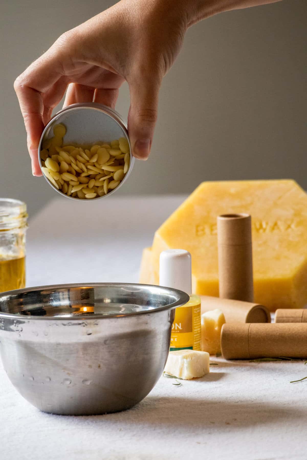 Adding beeswax pellets to olive oil lip balm