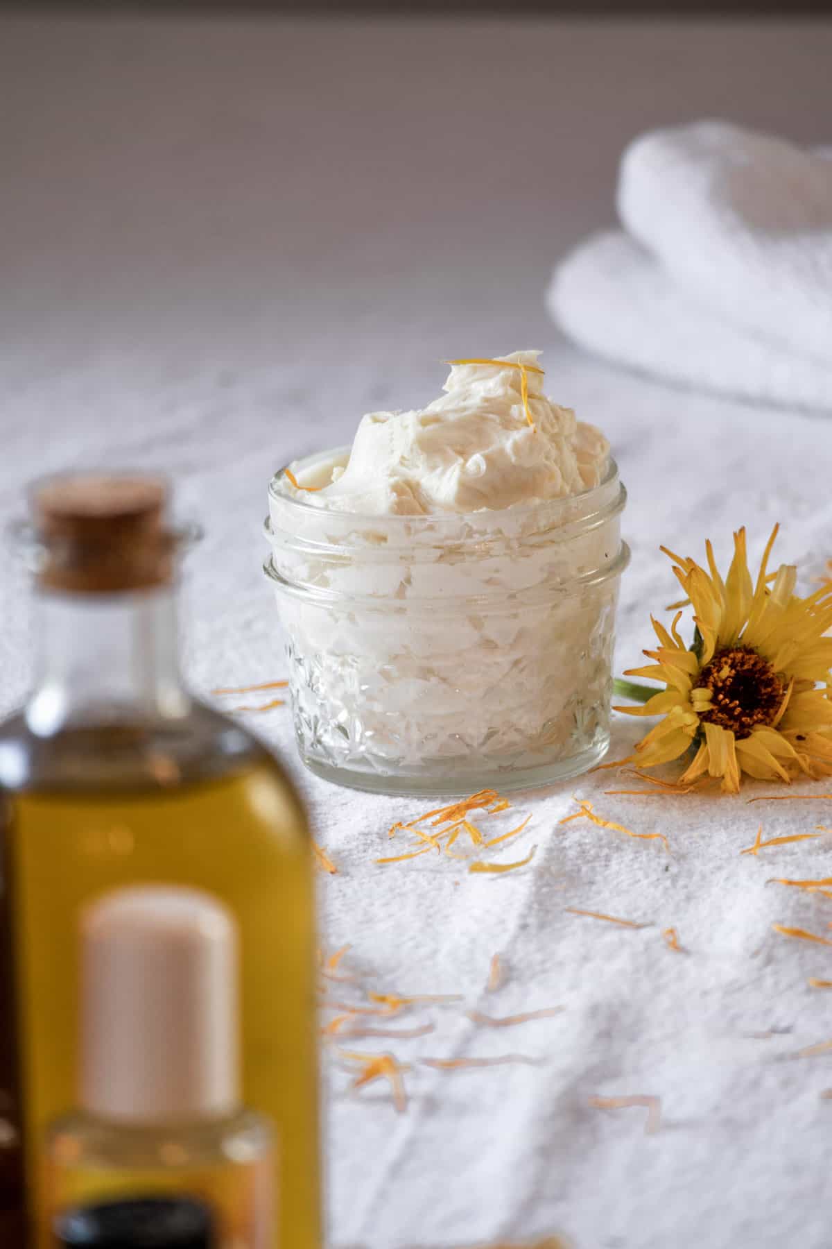 A small jar of whipped body butter on a table